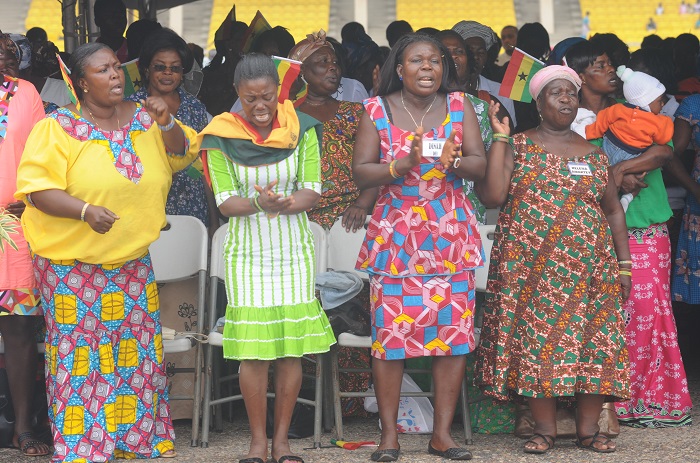 Some members of Aglow busily praying at the ceremony in Accra.